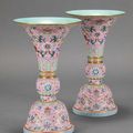 A pair of famille rose pink-ground gu-form vases, Jiaqing six-character seal marks in iron-red and of the period