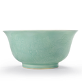 A rare large celadon-glazed relief-decorated bowl, Qianlong six-character seal mark in underglaze blue and of the period (1736-1