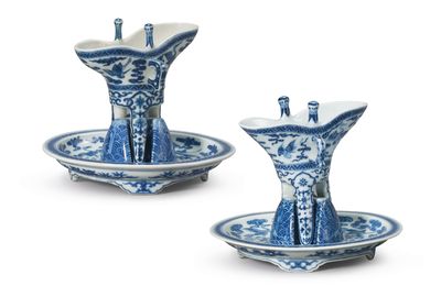 Two blue and white archaistic wine vessels and stands, jue, Qianlong four-character seal marks and of the period (1736-1795)