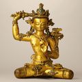 A superbly cast gilt-copper stone-inlaid seated figure of Manjusri, Nepal, 14th century