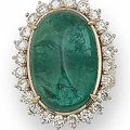 An 19.00 carats oval cabochon emerald and diamond cluster ring