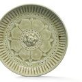 A fine Xiangzhou moulded celadon ‘floral’ dish, Northern Qi-Sui dynasty (550-618)