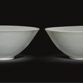 A pair of large white glazed anhua conical bowls.