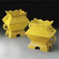 A rare pair of imperial yellow-glazed 'fu' and covers, Qing dynasty, 19th century