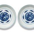 A pair of blue and white 'dragon and pheonix' saucer-dishes, Kangxi six-character marks and of the period (1662-1722)