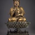 A large finely cast gilt-bronze figure of Guanyin, and a bronze stand, Ming dynasty, 16th-17th century