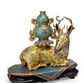 A rare pair of gilt-copper and cloisonné enamel figures of recumbent deer, Qianlong period (1736-1795)