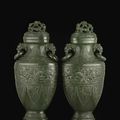 A pair of flattened archaistic spinach jade vases, hu Qing dynasty