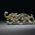 A very rare gilt-bronze feline-form ornament, North China, 1st-2nd century AD