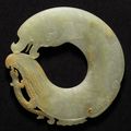 An archaistic celadon jade 'dragon-fish' disc, Late Ming dynasty 