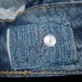 Réparation d'un bouton de jeans
