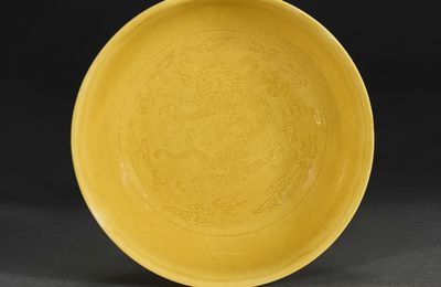 An incised yellow-glazed 'dragon' dish, Daoguang six character seal mark in underglaze blue and of the period (1821-1850)