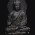 A monumental grey schist figure of seated Buddha Ancient region of Gandhara, Kushan period, first half of 3rd Century