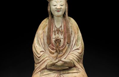 A rare large painted and white-glazed biscuit figure of a seated bodhisattva, 18th century