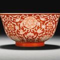 A coral-ground reserve-decorated ‘Lotus’ bowl, Qianlong seal mark and period 