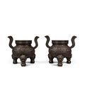 A rare pair of bronze 'dragon' tripod censers, Marks and period of Qianlong (1736-1795)