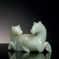 A pale greenish-white and russet jade carving of two horses, Qing dynasty (1644-1911)