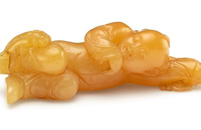 A superbly carved tianhuang 'Reclining boy' brushrest, 17th century