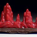 An unusual small red glass mountain-form brush rest