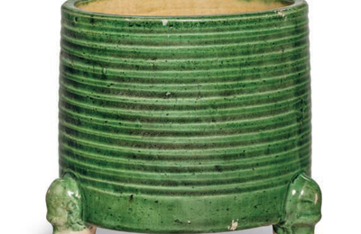 A small green and yellow-glazed cylindrical tripod censer, Tang dynasty (AD 618-907)