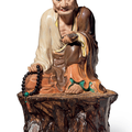 A polychrome-enameled and biscuit figure of a seated luohan, impressed seal of Zeng Longsheng, Republic period