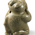 A rare 'Yue' celadon figure of a mythical beast, Western Jin dynasty (265-316)