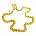 An opaque yellow glass bead necklace. Republic period