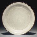 A molded Dingyao dish, Jin dynasty (1115-1234)