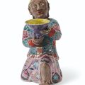 A Famille Rose Kneeling Figure, Qing Dynasty, 18th Century