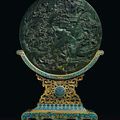A spinach-green jade circular table screen and a cloisonné enamel stand, Qing dynasty, Qianlong period (1736-1795)