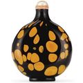 A realgar-splashed dark amber glass snuff bottle.  Imperial, Attributed to the Palace workshops, Beijing, 1730-1800