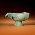 A rare archaic bronze 'Bird's-Head' libation cup, yi. Late Warring States Period