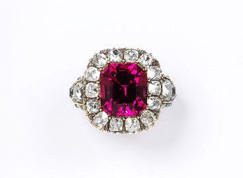 Red spinel with a border of brilliant-cut diamonds in a gold setting