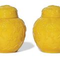 A pair of Chinese yellow glass ovoid jars and covers, late 19th-20th century