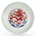 An iron-red-decorated blue and white 'dragon' dish, Wanli six-character mark and period  (1573-1619)