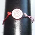 Perle en bois motif spirale, bracelet en coton ciré rouge et rose et attaches en argent