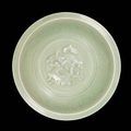 A celadon-glazed moulded 'dragon' dish. Yuan Dynasty