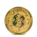 A large yellow-ground green and aubergine-enameled 'dragon' charger, Qing dynasty, Chuxiugong mark and Guangxu period (1875-1908