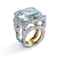 Fabergé. White and yellow gold ring with central tourmaline, diamonds, aquamarines and moonstones. 