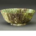 A mottled green hardstone chrysanthemum bowl