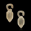 Pair of oblong-shaped pendant earrings probably adapting a vegetation form. Translucent glass. Vietnam, Đông Sơn Period (Bronze 