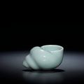 A rare celadon-glazed conch-shell shaped water pot, Qianlong four-character seal mark and of the period (1736-1795)