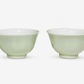 A pair of Chinese celadon glazed porcelain wine cups, Qianlong six character seal mark and possibly of the period 