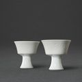A fine pair of white-glazed 'phoenix' stem cups, Marks and period of Yongzheng