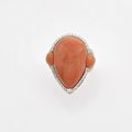 Repossi. Bague en or gris, ornée d'un cabochon en goutte de corail épaulé de deux motifs en goutte de corail dans un entourage 