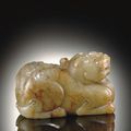 An unusual green and russet jade carving of a mythological animal, 17th century