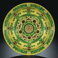 A fine large yellow and green 'Eight Buddhist Emblems' dish, seal mark and period of Qianlong (1736-1795)