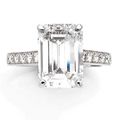 Boucheron. Bague en platine sertie d'un diamant taille émeraude, l'épaulement serti de diamants taillés en brillant