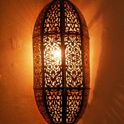 Moroccan brass wall light, sconce and its fine openwork pattern. Moroccan Design