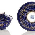 A fine gold painted enamel covered bowl with lotus design and fitting larger bowl, China, Qianlong seal mark and period